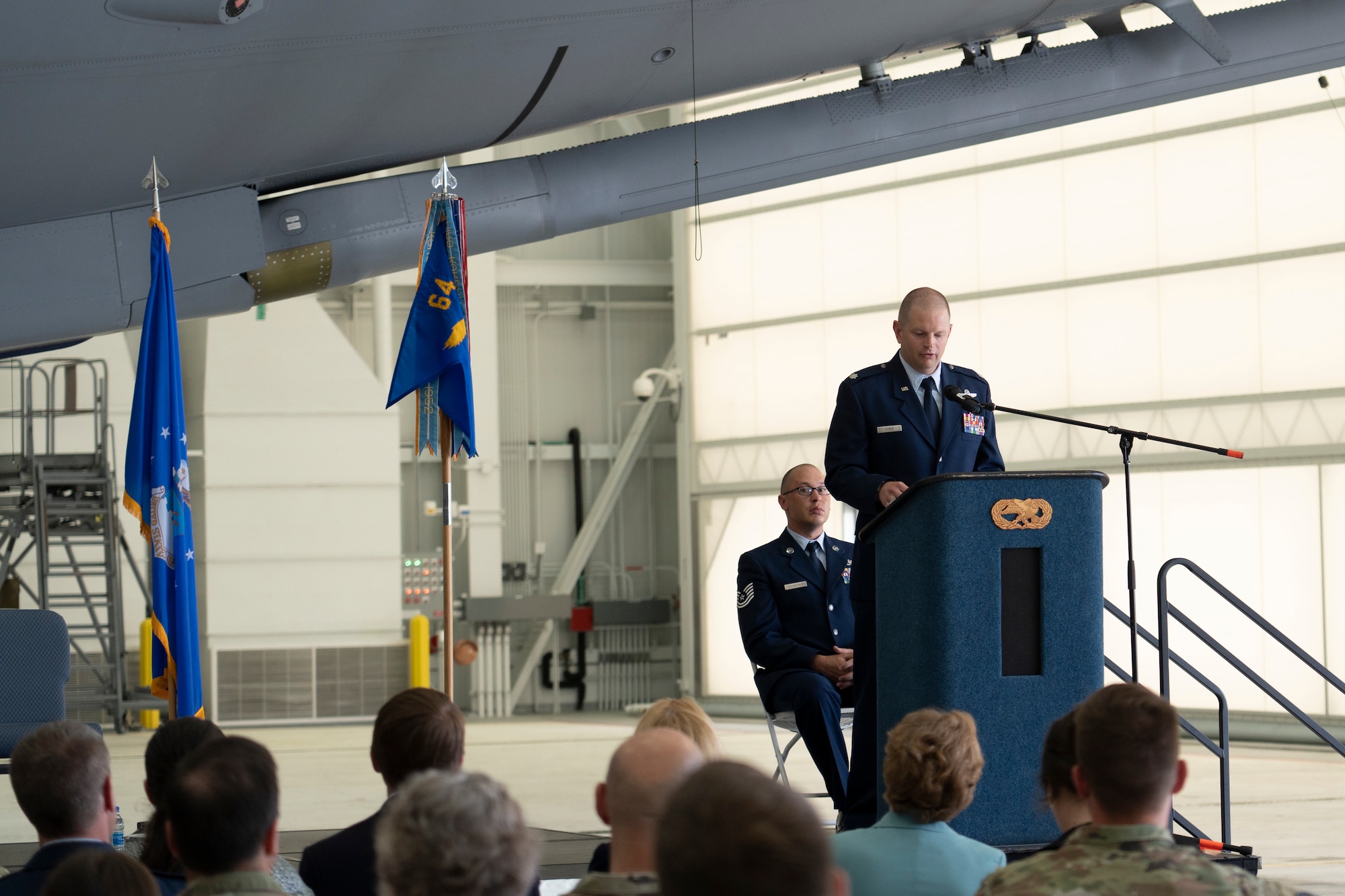 Lt. Col. Brandon Stock, incoming commander of the 64th Air Refueling Squadron, speaks to members of the New Hampshire congressional delegation, leadership from McConnell AFB, and Airmen from both units while on stage.