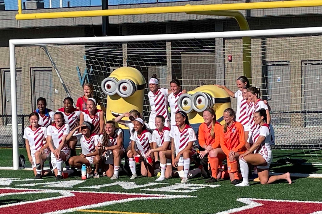 A female athletic team poses for a photo.