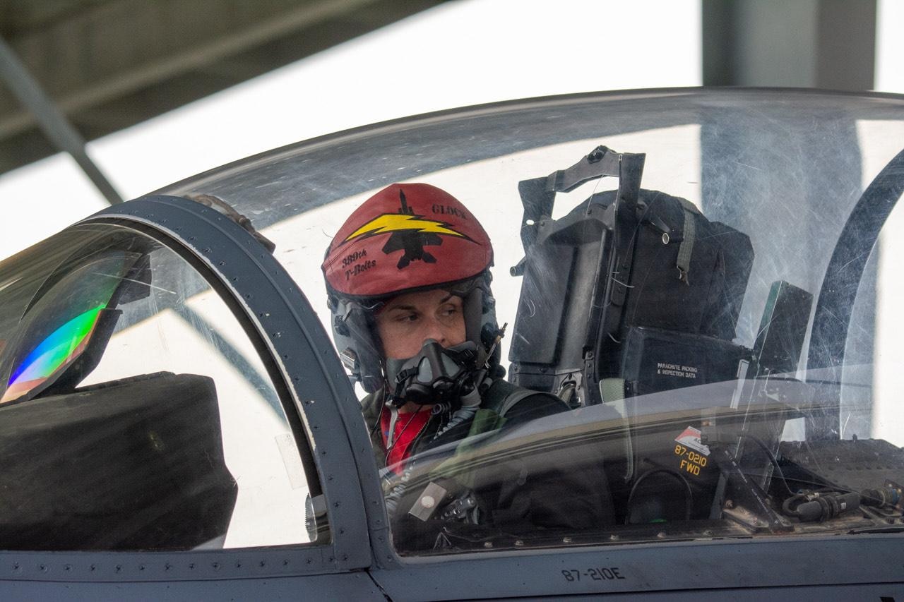 An airman sits in a jet.