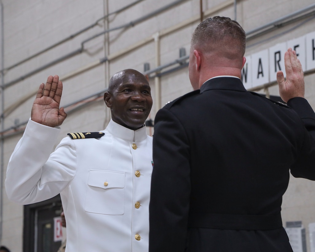 U.S. Navy Cmdr. Devon Foster, left, chaplain, Marine Aircraft Group 13 (MAG-13), 3rd Marine Aircraft Wing, recites the oath of office during his promotion ceremony at Marine Corps Air Station Yuma, Arizona, June 29, 2022.