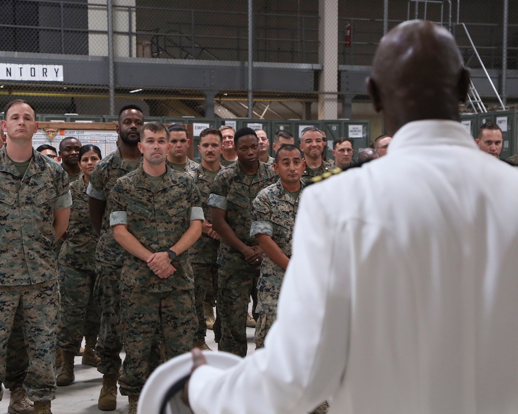 U.S. Navy Cmdr. Devon Foster, right, chaplain, Marine Aircraft Group 13 (MAG-13), 3rd Marine Aircraft Wing, speaks to the audience during his promotion ceremony at Marine Corps Air Station Yuma, Arizona, June 29, 2022. Foster is responsible for the moral, ethical, and spiritual readiness of Marines and Sailors of MAG-13. (U.S. Marine Corps photo by Lance Cpl. Jade Venegas)