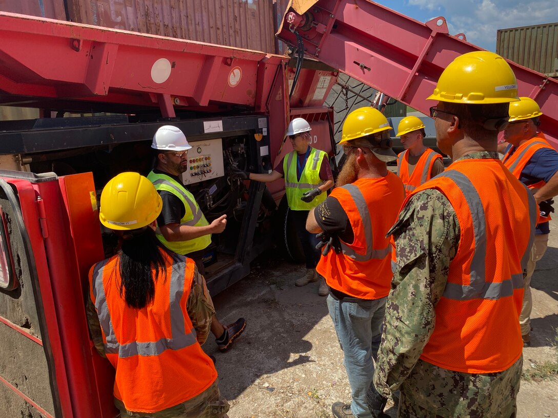 Men and women gathered around a shredder