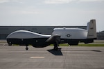 An MQ-4C arrives on the runway at Marine Corps Air Station Iwakuni, Japan, July 13, 2022. The MQ-4C is on a deployment to MCAS Iwakuni in support of continuing operations in the Indo-Paciﬁc area of operations. The 