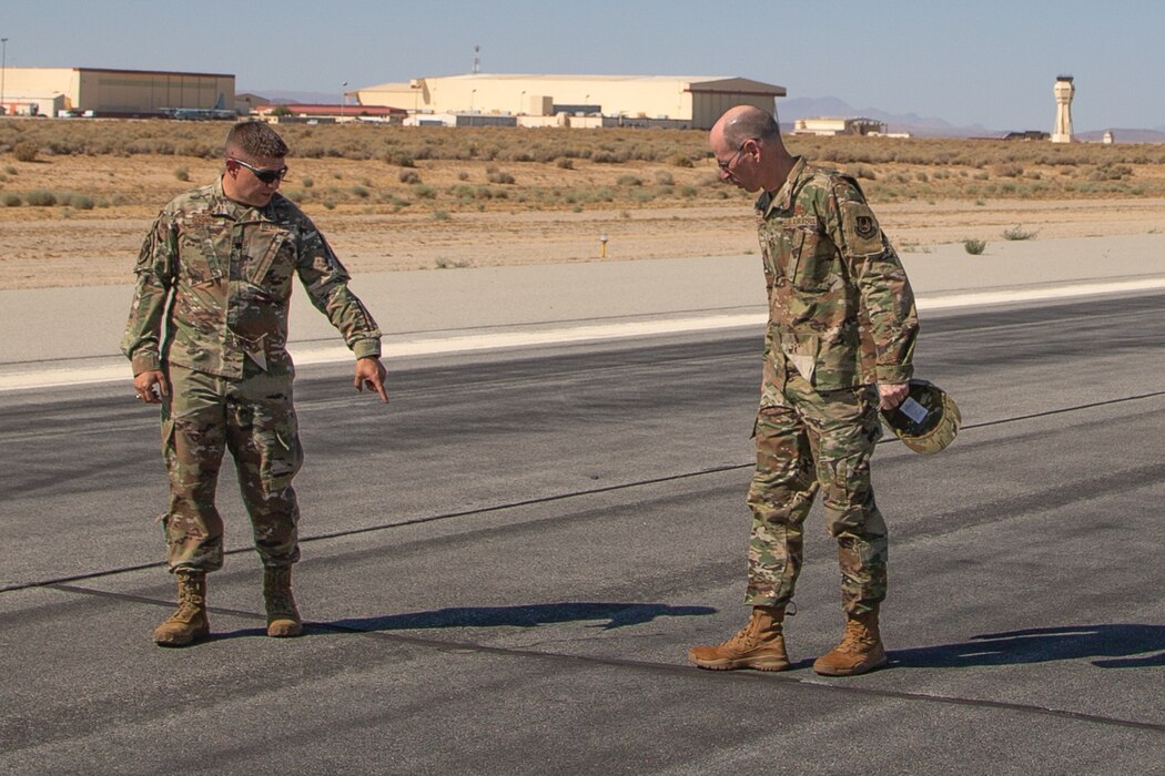 Lt. Col. Kristopher Rorberg, 412th Operations Support Squadron commander, briefs Gen. Duke Z. Richardson, Air Force Materiel Command commander, on the current status of the secondary runway on Edwards Air Force Base, California, July 12. Rorberg briefed Richardson on the runway’s condition and how it affects flight test missions on Edwards AFB. (U.S. Air Force photo by Todd Schannuth)