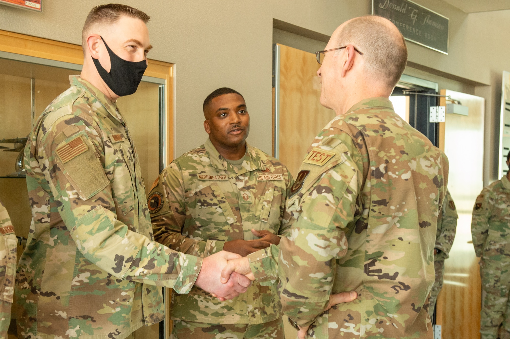Tech. Sgt. Nathan Wandrei, 412th Logistics Readiness Squadron, receives a coin from Gen. Duke Z. Richardson, Air Force Materiel Command commander, on Edwards Air Force Base, California, July 14. (U.S. Air Force photo by Lisa Dixon)