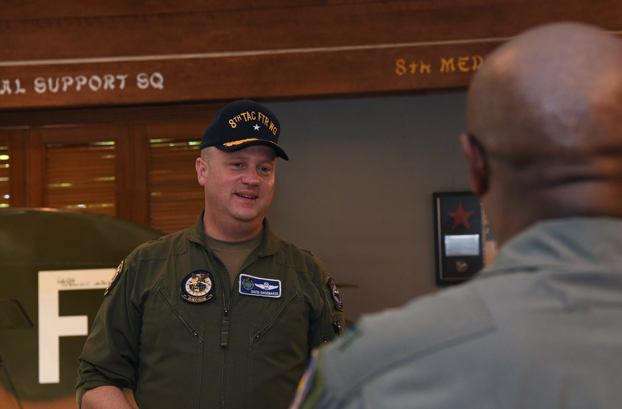 Two military members have a conversation after a ceremony.