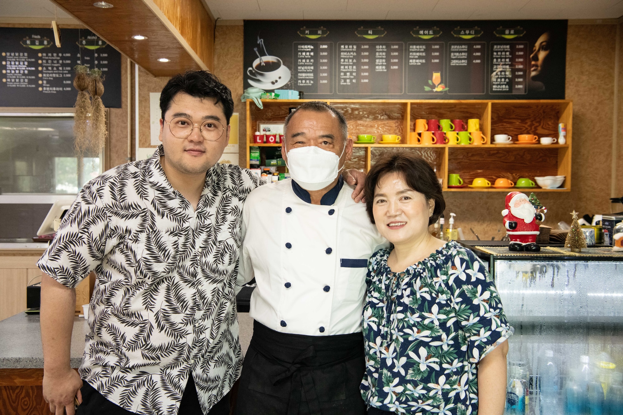 Geun Seo Sik, left, Jong Sik, middle, and Kyon-Suk Sik, owners of Gun Sung Maru, stand in their restaurant at Kunsan Air Base, Republic of Korea, July 8, 2022. The Sik family has been in the restaurant business for more than 20 years with five of those years serving Korean cuisine to the Wolf Pack community. (U.S. Air Force photo by Staff Sgt. Sadie Colbert)