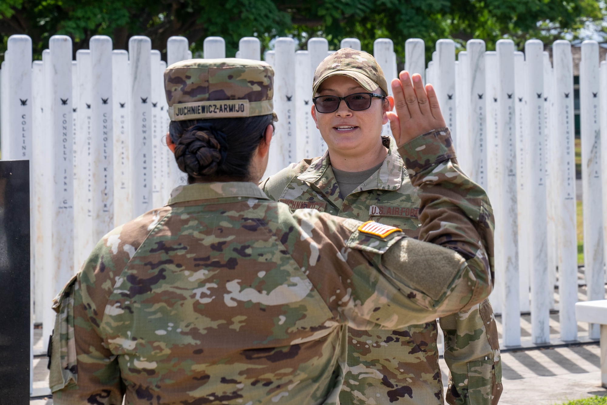 U.S. Air Force Tech. Sgt. Melissa Juchniewicz, 535th Airlift Squadron Squadron Aviation Resource Management journeyman, receives the reenlistment oath from U.S. Army Capt. Emily Juchniewicz-Armijo, 11th Expeditionary Combat Aviation Brigade medical service officer, at Joint Base Pearl Harbor-Hickam, Hawaii, June 30, 2022. Juchniewicz, originally from the To'hajiilee Navajo Reservation, joined the Air Force on March 10, 2009. (U.S. Air Force photo by Senior Airman Makensie Cooper)