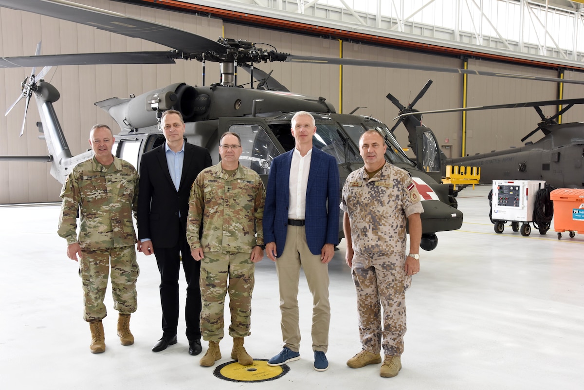 Left to right, U.S. Army Brig. Gen. Lawrence Schloegl, assistant adjutant general-Army, Latvian Ambassador Māris Selga, U.S. Army Maj. Gen. Paul Rogers, adjutant general and director, Michigan Department of Military and Veterans Affairs, Latvian Prime Minister Krišjānis Kariņš, and Defense Attaché Maj. Gen. Andis Dilāns tour the 3rd Battalion, 238th Aviation Regiment aircraft facility, Grand Ledge Armory, Michigan, July 1, 2022. For nearly 30 years, the Michigan National Guard and the National Armed Forces of Latvia have partnered under the Department of Defense National Guard Bureau State Partnership Program.