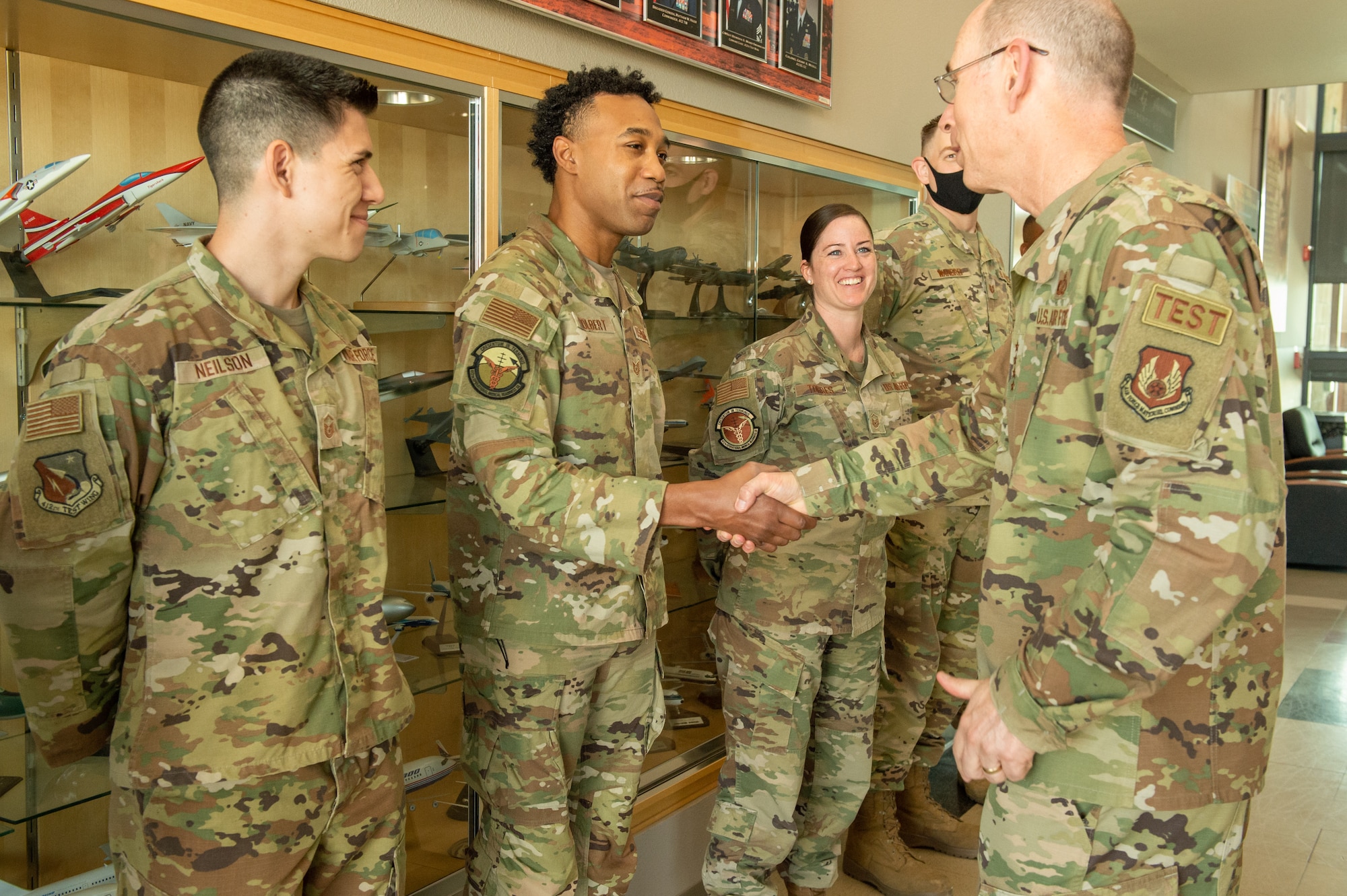Tech. Sgt. Ruben Tolbert, 412th Medical Group, receives a coin from Gen. Duke Z. Richardson, Air Force Materiel Command commander, on Edwards Air Force Base, California, July 14. (U.S. Air Force photo by Lisa Dixon)