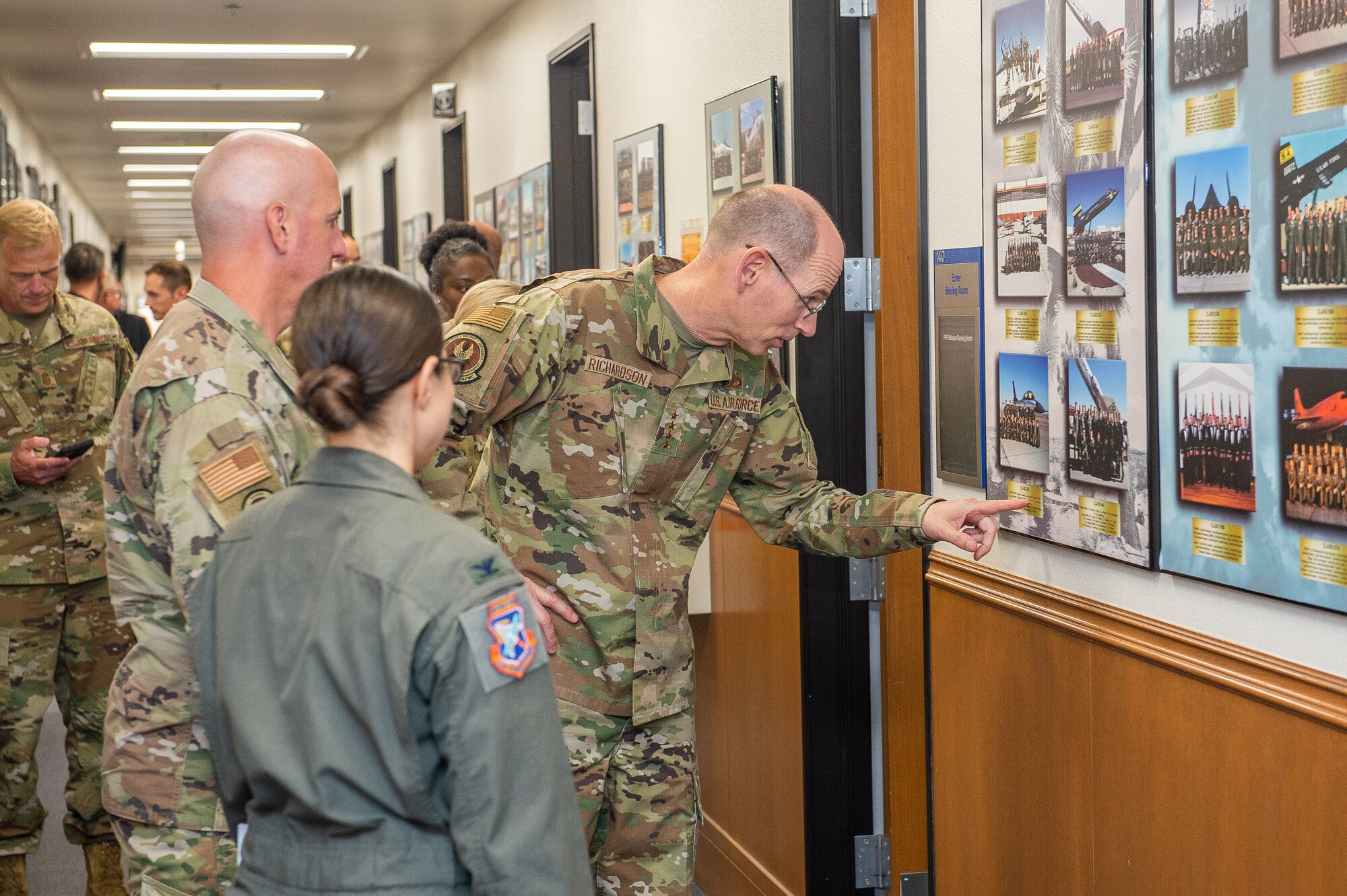 Gen. Duke Z. Richardson, Air Force Materiel Command commander, examines a class photo during his visit to the U.S. Air Force Test Pilot School on Edwards Air Force Base, California, July 13. Richardson toured the facility as he was briefed on the TPS curriculum. (U.S. Air Force photo by James West)