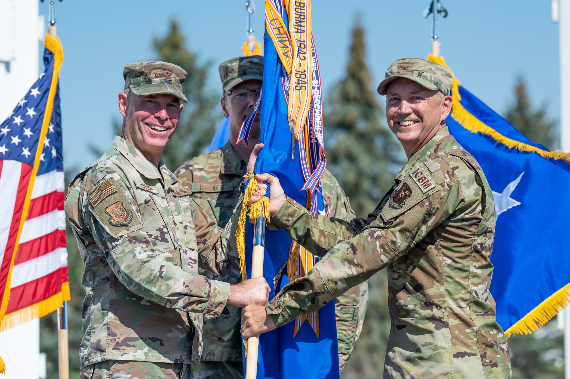Col. Barry Little, right, accepts the 341st Missile Wing guidon from Maj. Gen. Michael Lutton, left, 20th Air Force commander, during a change of command ceremony July 18, 2022, at Malmstrom Air Force Base, Mont.