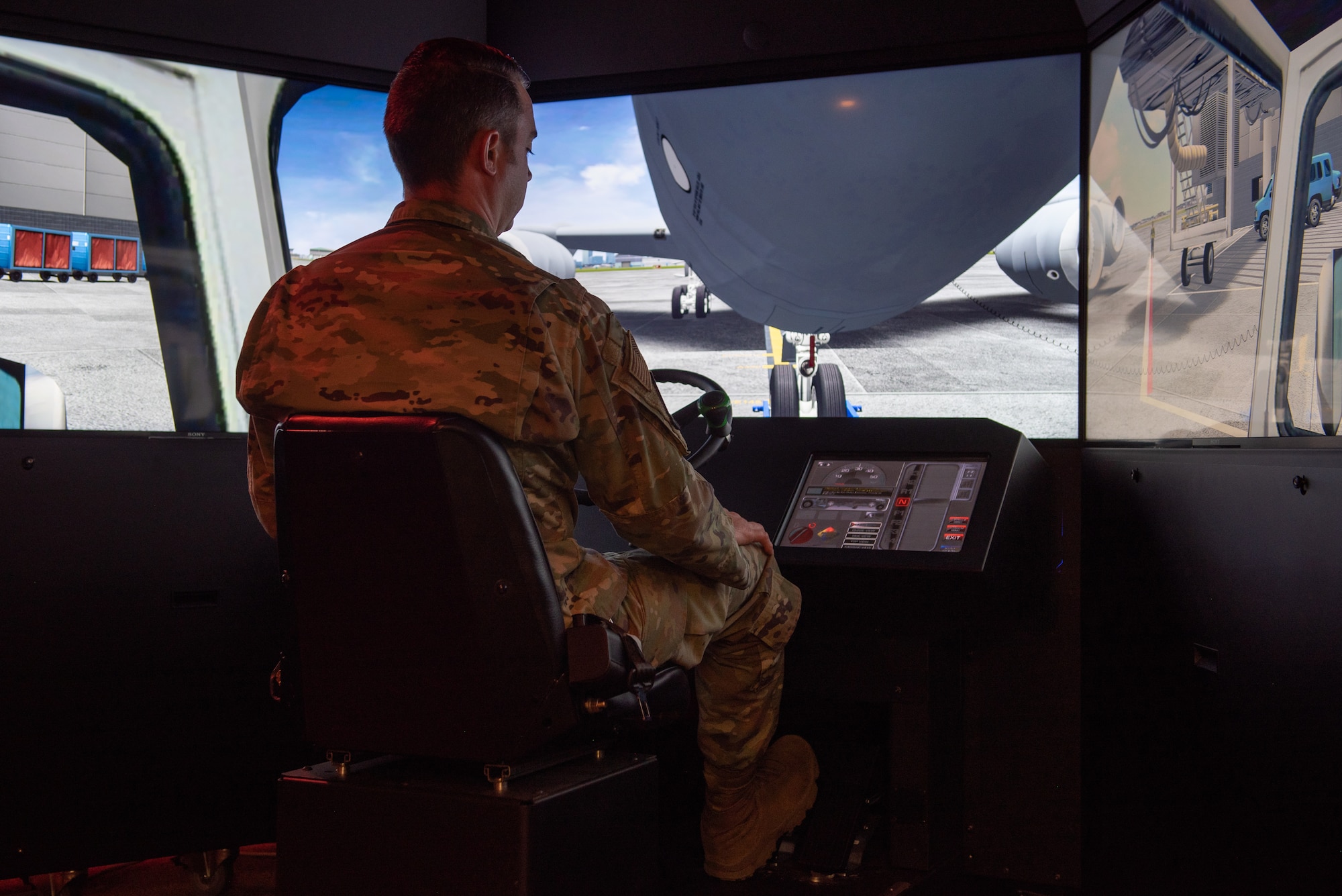 U.S. Air Force Tech. Sgt. Brent Noah, 92nd Maintenance Group Maintenance Qualification Training Program instructor, demonstrates the virtual aircraft pullback simulation at Fairchild Air Force Base, Washington, July 14, 2022. The simulator uses virtual reality technology, creating a low-risk, hands-on environment for Airmen to familiarize themselves with the equipment and process of moving aircraft throughout the flight line. (U.S. Air Force photo by Airman 1st Class Morgan Dailey)