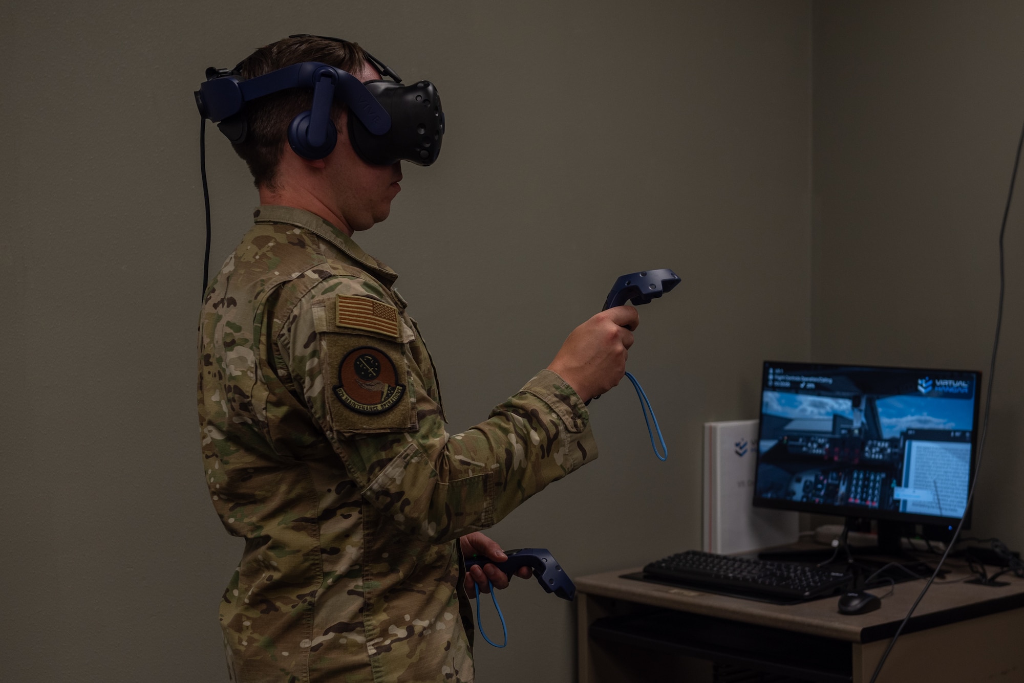 U.S. Air Force Tech. Sgt. Christian Klimek, 92nd Maintenance Group Maintenance Qualification Training Program instructor, demonstrates the virtual reality headset modules for the KC-135 Stratotanker at Fairchild Air Force Base, Washington, July 14, 2022. Benefits of the new training technology include reducing the amount of time it would take to train an Airman on pushing an aircraft back, instructors now being able to provide more specific feedback within the virtual space, and projected savings up to $172 million in fuel, manning and equipment per year. (U.S. Air Force photo by Airman 1st Class Morgan Dailey)