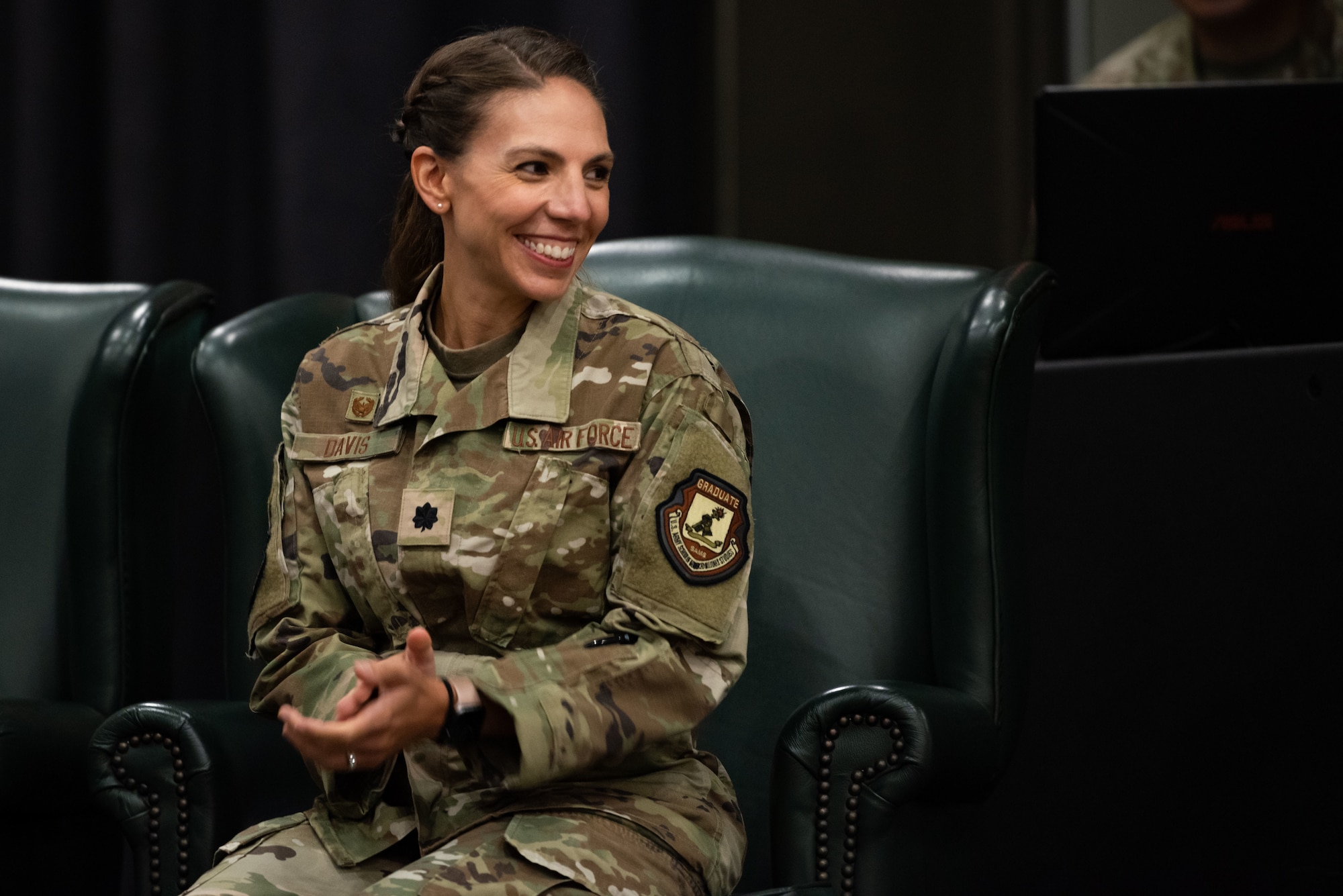 Lt. Col. Megan Davis, 303rd Intelligence Squadron incoming commander, smiles at her family during the squadron’s assumption of command at Osan Air Base, Republic of Korea, July 18, 2022.