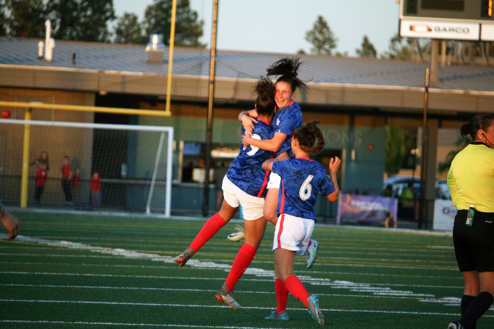 France's Aissa Belkasni (#19) celebrates with teammates after scroing their fist goal against Canada in match 16 of the 13th Conseil International du Sport Militaire (CISM) World Women's Military Football Championship hosted by Fairchild Air Force Base in Spokane, Washingon.  This year's championship features teams from the United States, Belgium, Cameroon, Canada, France, Germany, Ireland, Mali, Netherlands, and South Korea.  (Department of Defense Photo by Mr. Steven Dinote, released).
