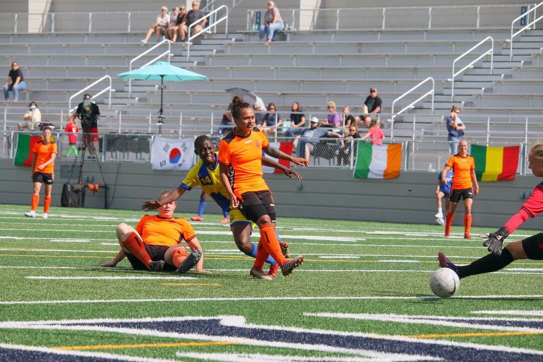 Mali's Oumou Kone laser guides her shot past Dutch defenders and the goalkeep to score in match 15 of the 13th Conseil International du Sport Militaire (CISM) World Women's Military Football Championship hosted by Fairchild Air Force Base in Spokane, Washingon.  This year's championship features teams from the United States, Belgium, Cameroon, Canada, France, Germany, Ireland, Mali, Netherlands, and South Korea.  (Department of Defense Photo by Mr. Steven Dinote, released).