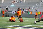 Mali's Oumou Kone laser guides her shot past Dutch defenders and the goalkeep to score in match 15 of the 13th Conseil International du Sport Militaire (CISM) World Women's Military Football Championship hosted by Fairchild Air Force Base in Spokane, Washingon.  This year's championship features teams from the United States, Belgium, Cameroon, Canada, France, Germany, Ireland, Mali, Netherlands, and South Korea.  (Department of Defense Photo by Mr. Steven Dinote, released).