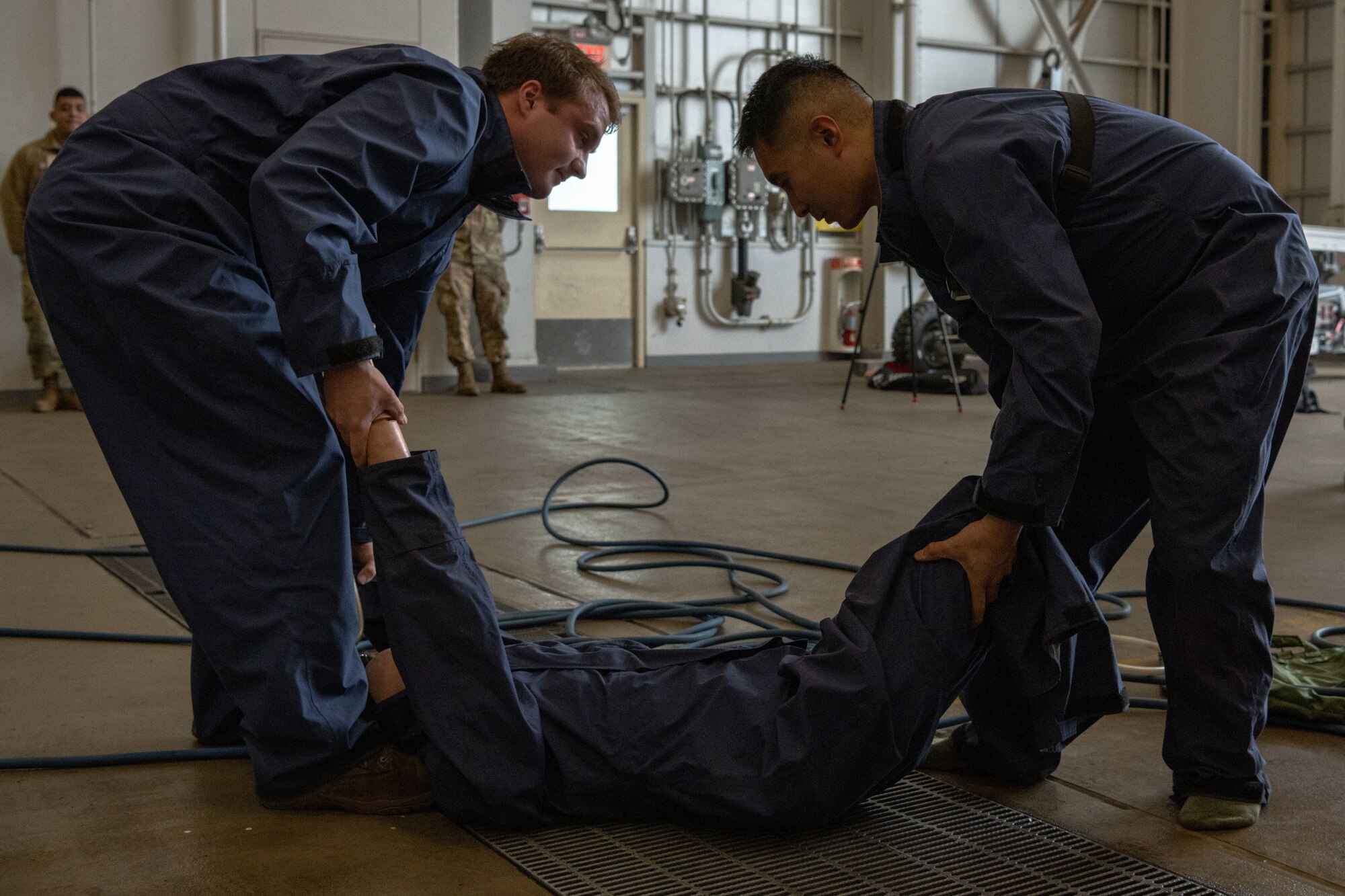 People in uniform work on an aircraft