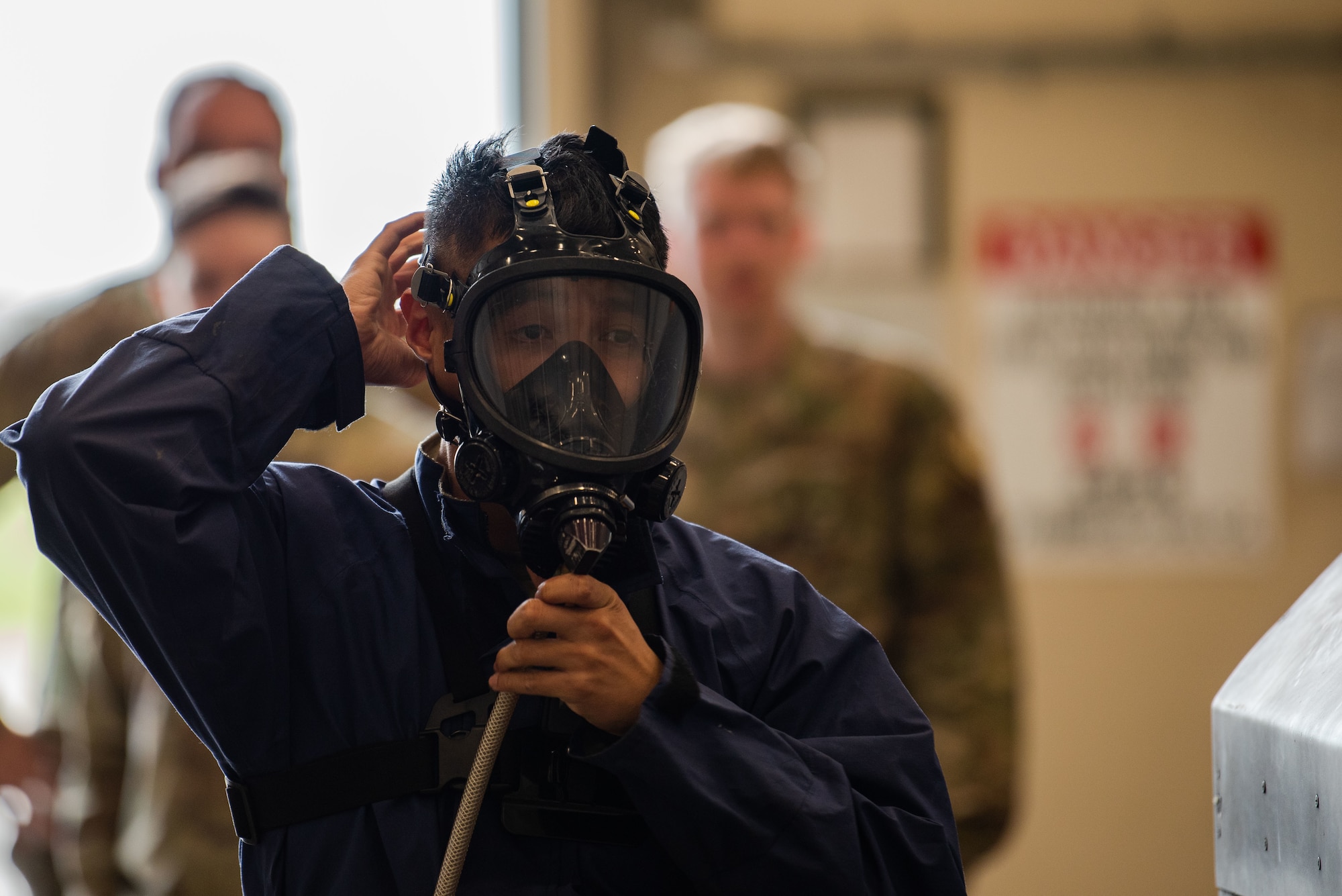 People in uniform work on an aircraft