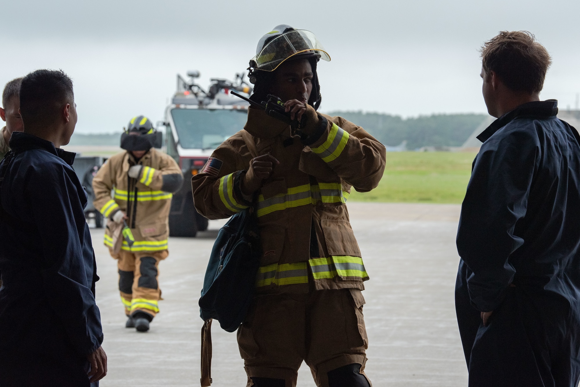 People in uniform work on an aircraft