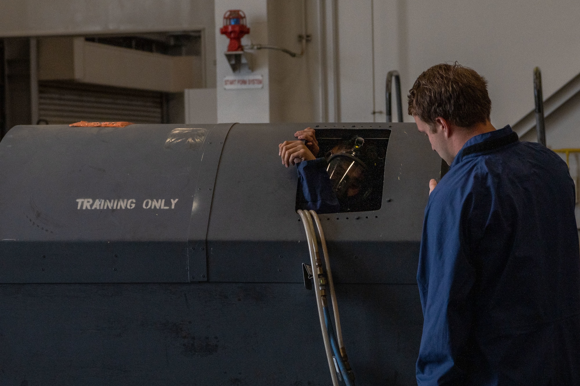 People in uniform work on an aircraft