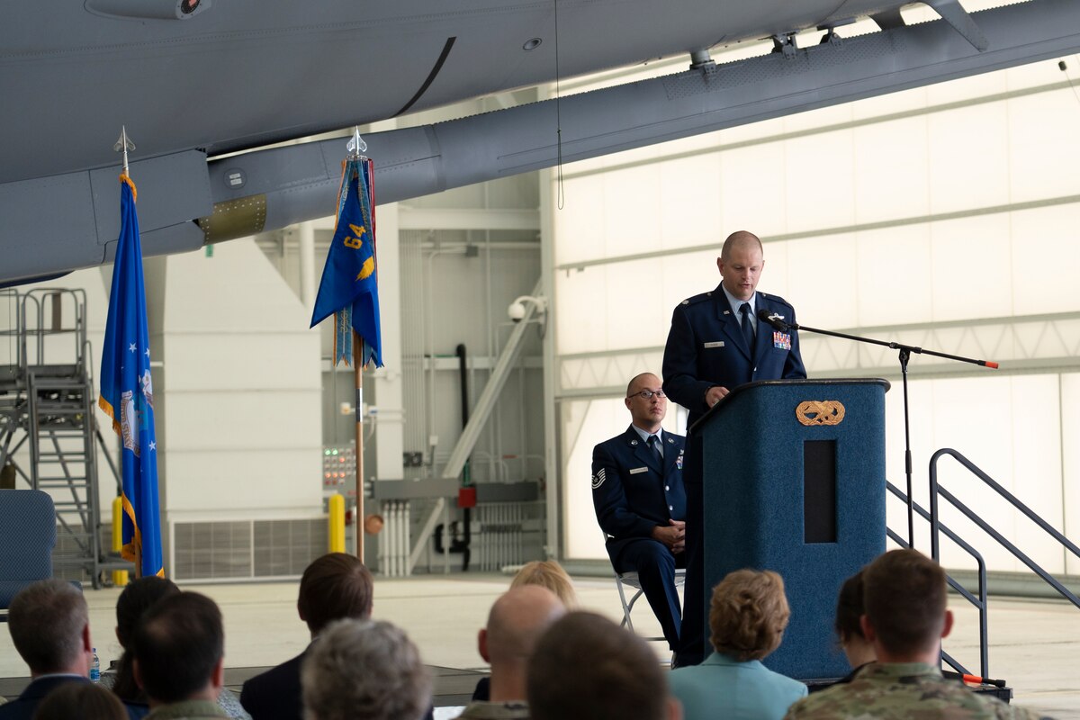 Lt. Col. Brandon Stock, incoming commander of the 64th Air Refueling Squadron, speaks to members of the New Hampshire congressional delegation, leadership from McConnell AFB, and Airmen from both units during an assumption of command ceremony held at Pease Air National Guard Base on July 8, 2022, in Newington, New Hampshire. The 64th was temporarily returned to help support the 157th Air Refueling Wing's new complement of a dozen KC-46A refuelers. (U.S. Air National Guard photo by Staff Sgt. Taylor Queen)