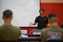 Allen Sese, the High Intensity Tactical Training (HITT) Coordinator with Fleet Marine Force, Atlantic, Marine Forces Command, Marine Forces Northern Command, Headquarters and Service Battalion gives a lecture on physical training during a HITT course in the Hopkins Hall Gymnasium at Camp Elmore, Virginia, July 11, 2022. HITT is a comprehensive strength and conditioning program that focuses on maintaining and improving physical resiliency and combat readiness. Marines who graduate from the course are knowledgeable resources for physical training within their respective units. (U.S. Marine Corps photo by Lance Cpl. Jack Chen)