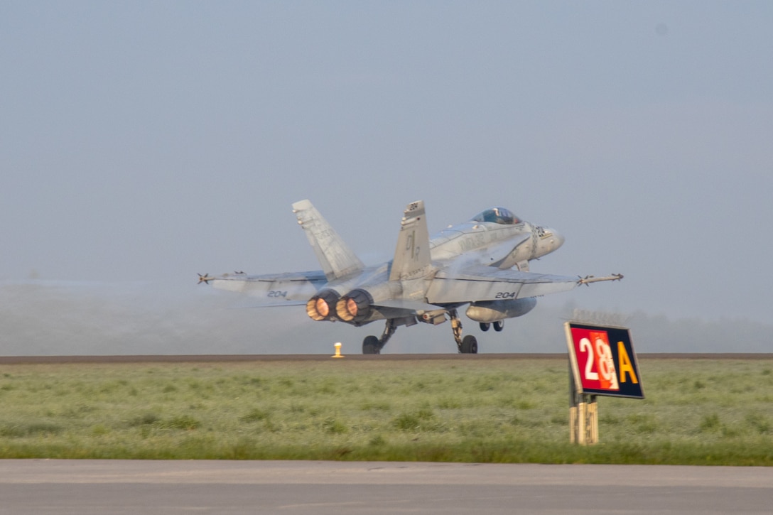 A U.S. Marine Corps F/A-18 Hornet, assigned to Marine Fighter Attack Squadron (VMFA) 312, 2nd Marine Aircraft Wing (MAW), takes off for flight from Łask Air Base, Poland, April 27, 2022. 2nd MAW units are deployed to enhance NATO's capabilities in Eastern Europe at the invitation of the host nation. (U.S. Marine Corps photo by Cpl. Adam Henke)