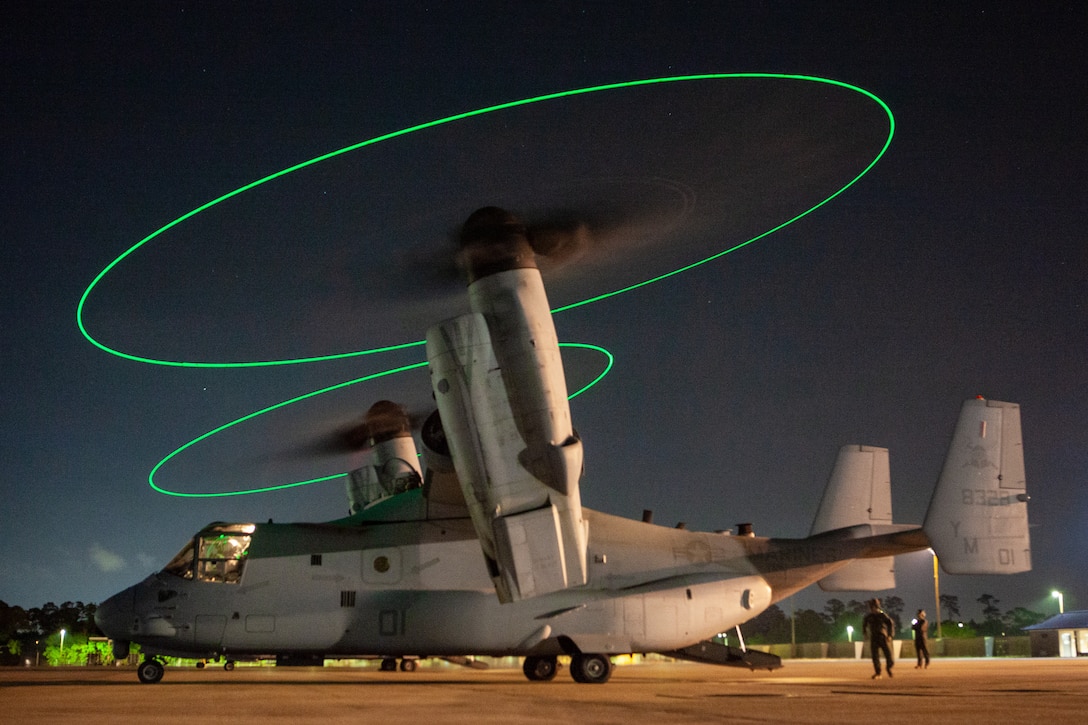 U.S. Marines with Marine Medium Tiltrotor Squadron (VMM) 365 conduct preflight inspections on an MV-22B Osprey prior to flight during Exercise Raven (RavenEx) 22-5 at Combat Readiness Training Center, Gulfport, Mississippi, May 8, 2022. VMM-365 provided assault support for Marine Forces Special Operations Command during a predeployment training exercise to enhance combat readiness in an unfamiliar expeditionary environment. VMM-365 is a subordinate unit of 2nd Marine Aircraft Wing, the aviation combat element of II Marine Expeditionary Force. (U.S. Marine Corps photo by Lance Cpl. Christian Cortez)