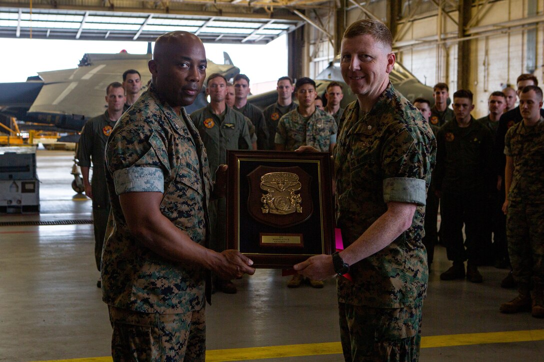 U.S. Marine Corps Col. Marlin D. Williams, left, commanding officer of Marine Aircraft Group (MAG) 14, and Lt. Col. Phillip T. Ash, commanding officer of Marine Attack Squadron (VMA) 223, pose for a photo with the Chief of Naval Operations 2020 Naval Aviation Safety Award at Marine Corps Air Station Cherry Point, North Carolina, May 23, 2022. The chief of naval operations recognized the squadron for its outstanding safety record during aircraft operations in support of the United States Marine Corps Forces Command. MAG-14 and VMA-223 are subordinate units of 2nd Marine Aircraft Wing (MAW), the aviation combat element of II Marine Expeditionary Force. (U.S. Marine Corps photo by Lance Cpl. Elias E. Pimentel III)