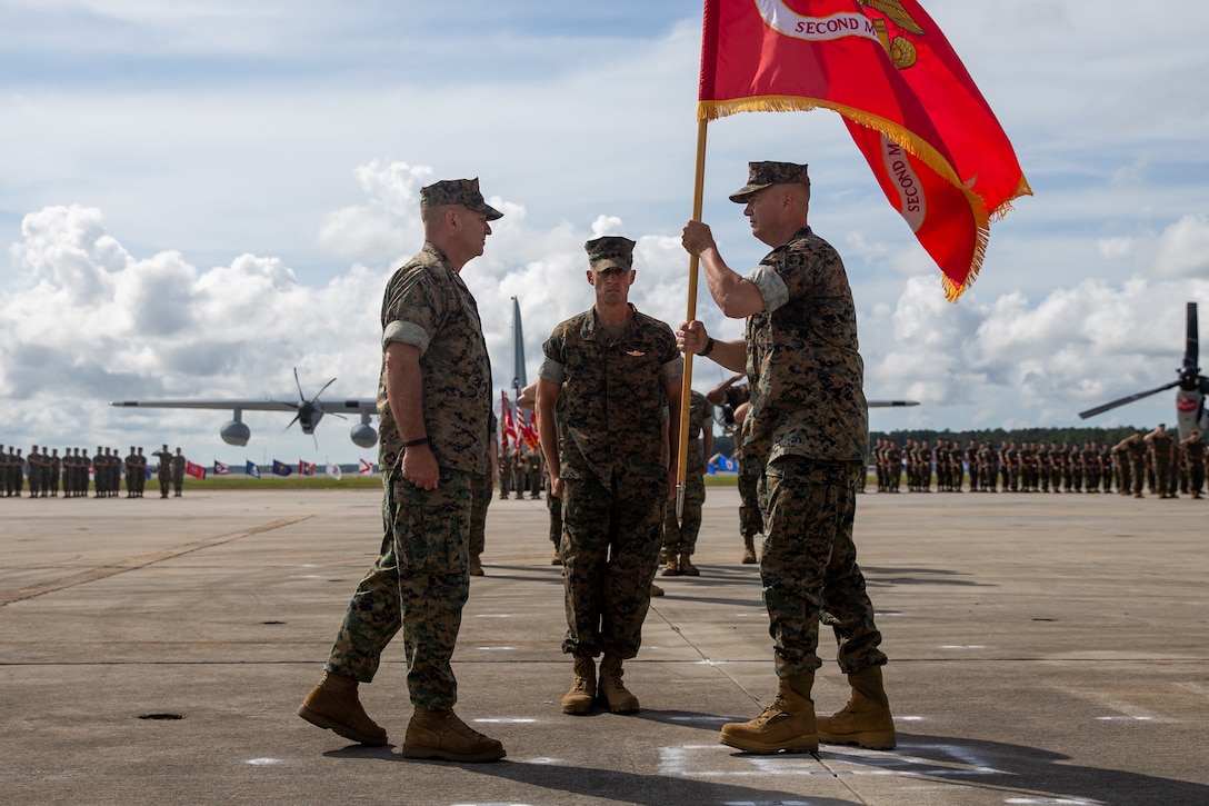 U.S. Marine Corps Maj. Gen. Michael S. Cederholm, right, passes the ceremonial colors to Maj. Gen. Scott F. Benedict, during a change of command ceremony at Marine Corps Air Station Cherry Point, North Carolina, June 30, 2022. The ceremony represented a transfer of responsibility, authority, and accountability from Cederholm to Benedict. 2nd MAW is the aviation combat element of II Marine Expeditionary Force. (U.S. Marine Corps photo by Lance Cpl. Elias E. Pimentel III)