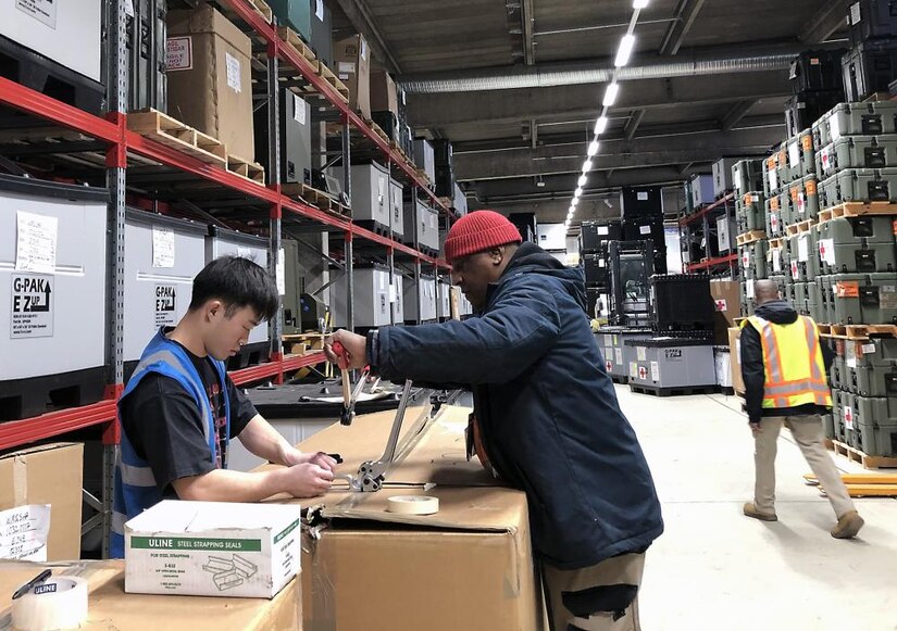Cpl. Thien Nguyen, left, medical supply technician with the 551st Medical Logistics Company, and Karl Posley, a general supply specialist with the U.S. Army Medical Materiel Agency, prepare shipments of medical supplies at the Army Prepositioned Stocks site in Germany, known as APS-2.