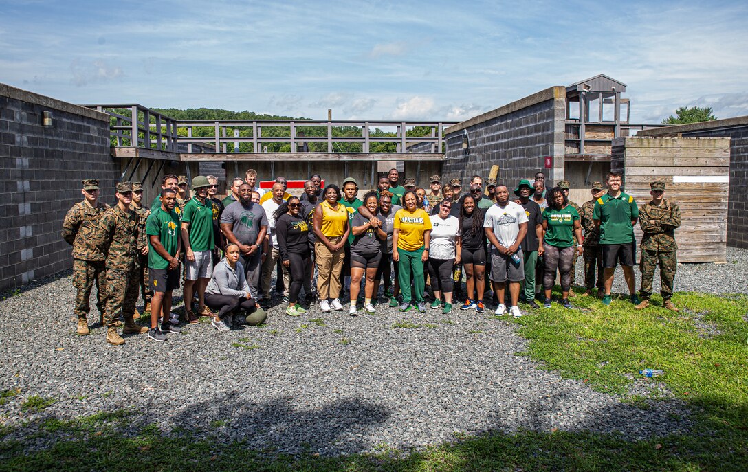 Coaches and athletic staff from Norfolk State University pose for a group photo with U.S. Marine instructors from Officer Candidate School after training on the Leadership Reaction Course at OCS aboard Marine Corps Base Quantico, Virginia on July 18, 2022. The coaches, athletic staff, and directors worked on team building and enhanced their leadership and problem-solving skills with help from the Marines during their annual retreat. (U.S. Marine Corps Photo by Lance Cpl. Gustavo Romero)"