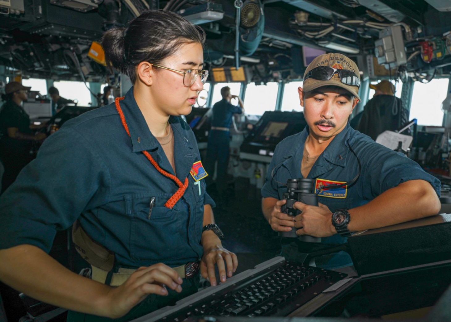 Lt. j.g. Nicole Schiff, left, from Silver Spring, Maryland, and Lt. j.g. Dominic Estevez, right, from San Diego, monitor surface contacts from the pilothouse as the guided-missile destroyer USS Benfold (DDG 65) conducts routine underway operations. Benfold is forward-deployed to the U.S. 7th Fleet area of operations in support of a free and open Indo-Pacific.