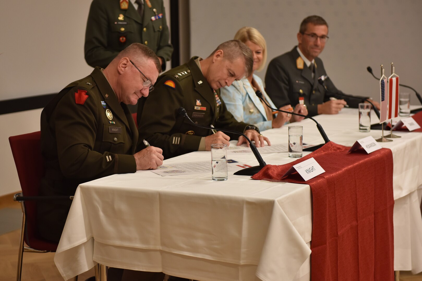 U.S. Army Brig. Gen. Gregory Knight (left), Vermont Adjutant General, and U.S. Army Gen, Daniel Hokanson (center left), Chief of the National Guard Bureau, sign the letters of intent during the Vermont National Guard and Republic of Austria’s Letter of Intent signing ceremony, July 19, 2022, Vienna, Austria.  This will be the third state partnership for the Vermont National Guard, which includes partnerships with North Macedonia since 1993 and Senegal since 2008. (U.S. Army National Guard Photo by 1st Lt. Nathan Rivard)