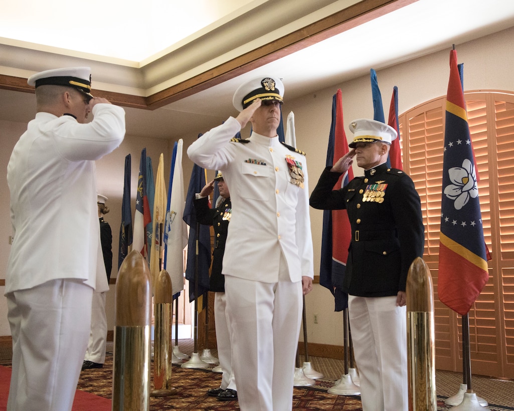 U.S. Navy Cmdr. Gareth Montgomery, center, outgoing director of Installation and Logistics (I&L), Marine Corps Air Station Yuma, Arizona, returns a salute during his retirement ceremony aboard the installation, July 11, 2022.