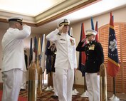 U.S. Navy Cmdr. Gareth Montgomery, center, outgoing director of Installation and Logistics (I&L), Marine Corps Air Station Yuma, Arizona, returns a salute during his retirement ceremony aboard the installation, July 11, 2022. Montgomery directed I&L for two years and retired after 22 years of service. (U.S. Marine Corps photo by Lance Cpl. Jade Venegas)