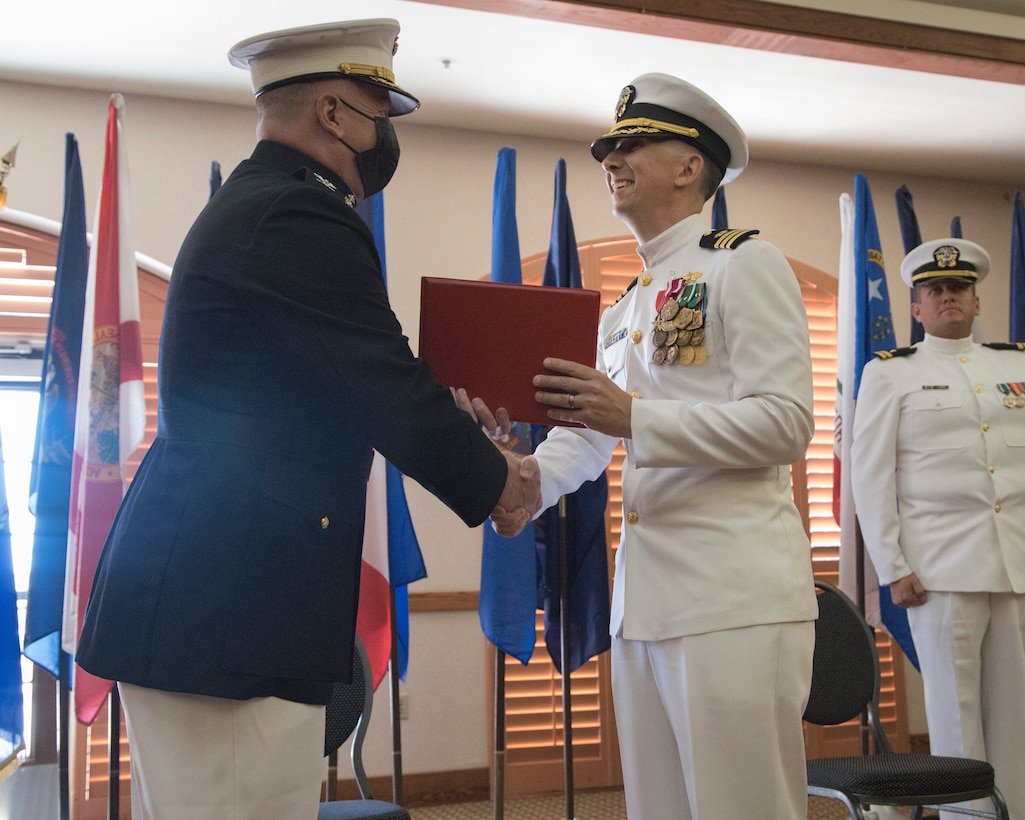 U.S. Navy Cmdr. Gareth Montgomery, right, outgoing director of Installation and Logistics (I&L), Marine Corps Air Station (MCAS) Yuma, Arizona, is awarded the Meritorious Service Medal by U.S. Marine Corps Col. Charles Dudik, commanding officer, MCAS Yuma, Arizona, during his retirement ceremony aboard the installation, July 11, 2022.