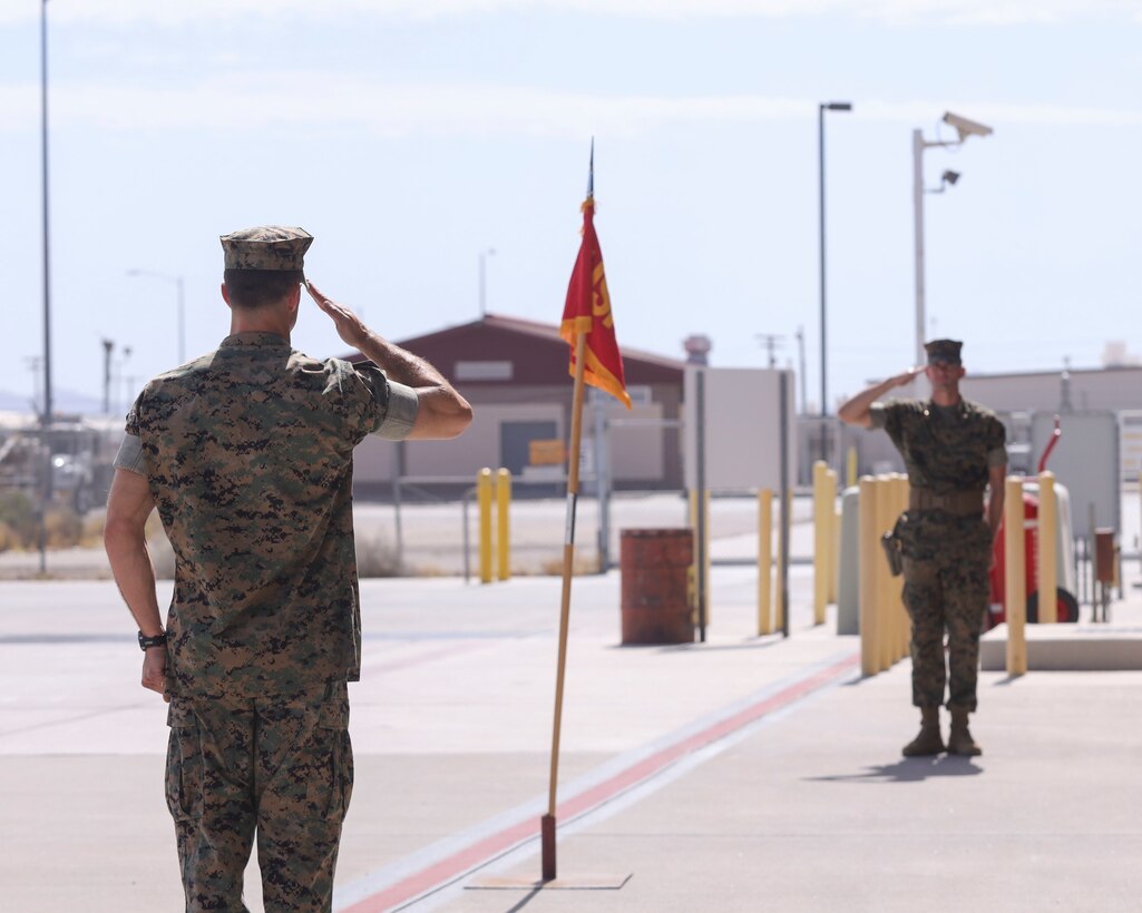U.S. Marine Corps Lt. Col. Michael Hayes, left, oncoming commanding officer, Headquarters and Headquarters Squadron (H&HS), Marine Corps Air Station Yuma, Arizona, returns a salute to Maj. Joshua Sharp, executive officer, H&HS, during a change of command ceremony aboard the installation, June 30, 2022.