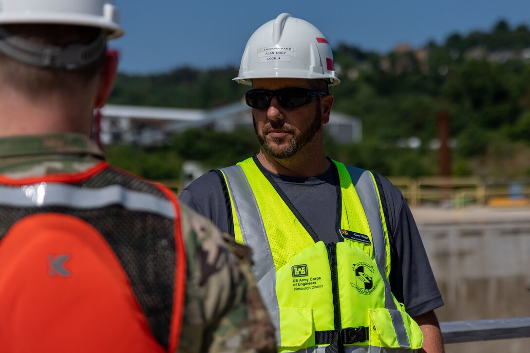 Lockmaster Alan Nogy discusses the Lower Mon project. On July 15, Deputy Commanding General Heitkamp visited the Pittsburgh District to tour the construction work at Charleroi Locks and Dam 4 in Belle Vernon, PA. The construction work is part of the Lower Monongahela River project, which will replace the nearly 100-year-old fixed-crest dam with a gated dam at Braddock Locks and Dam 2, remove Locks and Dam 3 in Elizabeth and construct two larger locks at Charleroi Locks and Dam 4 in Belle Vernon. The Braddock, Elizabeth and Charleroi locks are the three oldest operating-navigation facilities on the Monongahela River and experience the highest commercial-traffic volume in the entire Monongahela River Navigation System. (U.S. Army Corps of Engineers photo by Andrew Byrne)