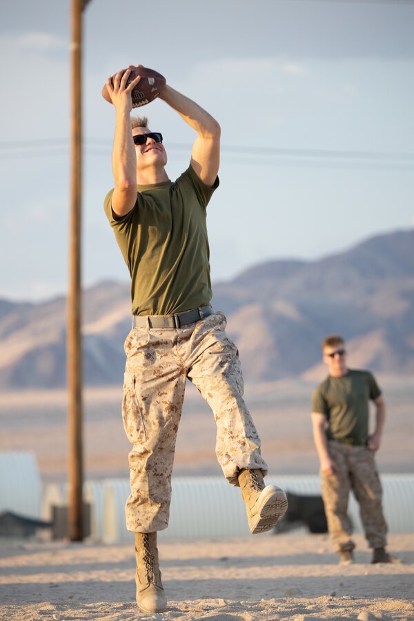 U.S. Marine Corps Cpl. Zachary Newmann, a semitrailer refueler operator assigned to Bravo Company, Marine Wing Support Squadron 473, 4th Marine Aircraft Wing, from Groesbeck, Texas, catches a football at Camp Wilson, Marine Corps Air-Ground Combat Center, Twentynine Palms, Calif., during Integrated Training Exercise (ITX) 4-22, July 17, 2022. Reserve Marines and Sailors have come together from across the nation to form an integrated Marine Air-Ground Task Force to take part in a live-fire, combined arms exercise that will better prepare Marine Forces Reserve in its mission to augment and reinforce the Active Component. (U.S. Marine Corps Video by Cpl. James Stanfield)