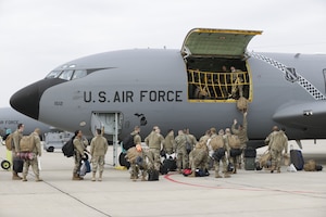 Members of the 127th Wing load bags onto a KC-135 Stratotanker in advance of an overseas deployment here, on October 12, 2021. As of February 28, 2022, 127th Wing airmen are deployed around the world in every combatant command area of responsibility, for the first time in the unit's history