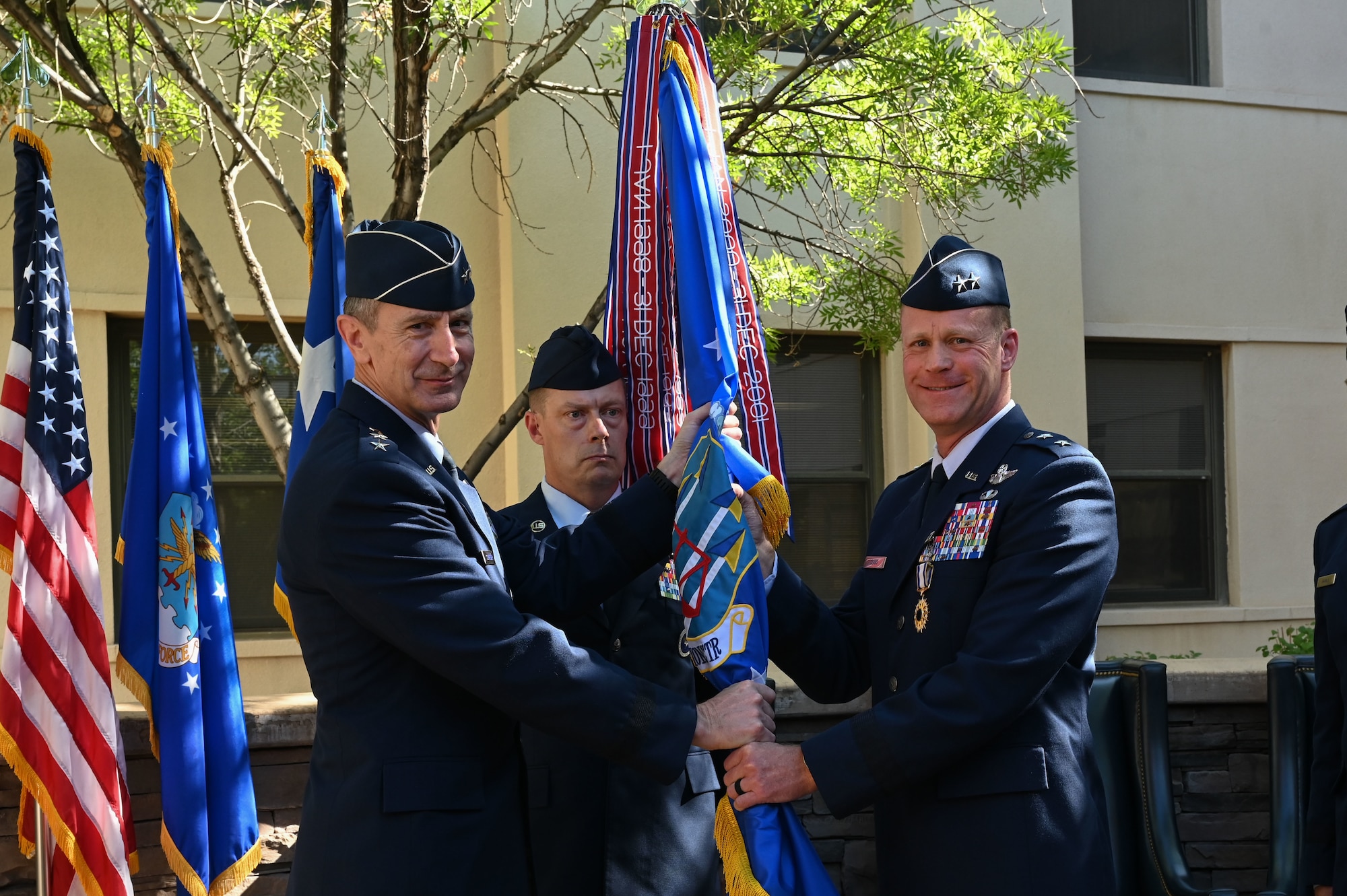 A man passes a guidon to another man.