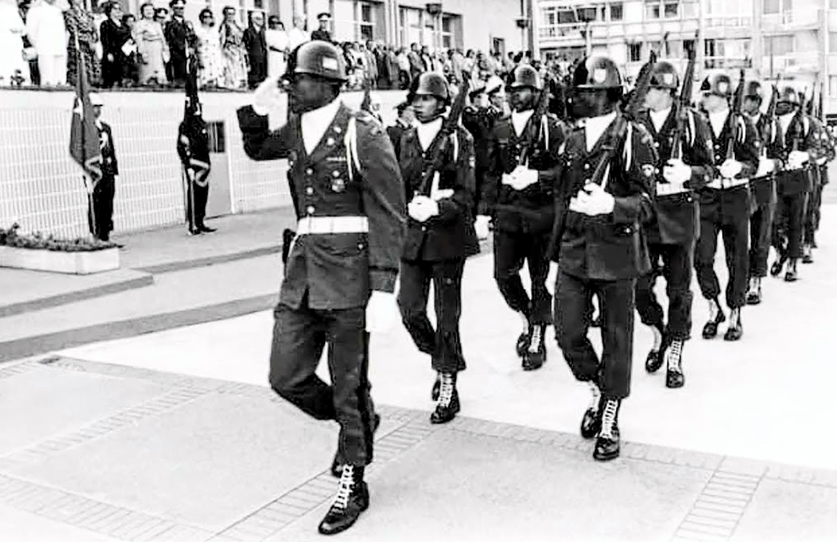 Black and white photos of a man leading a group of soldiers in uniform