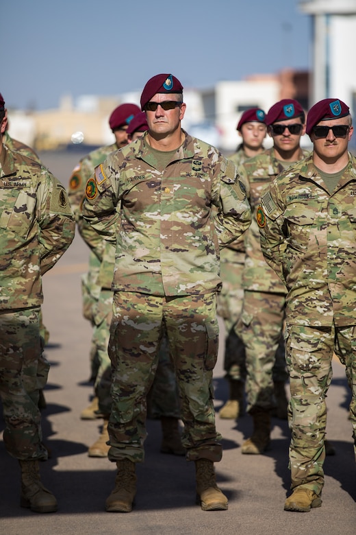 Soldiers stand in a formation.