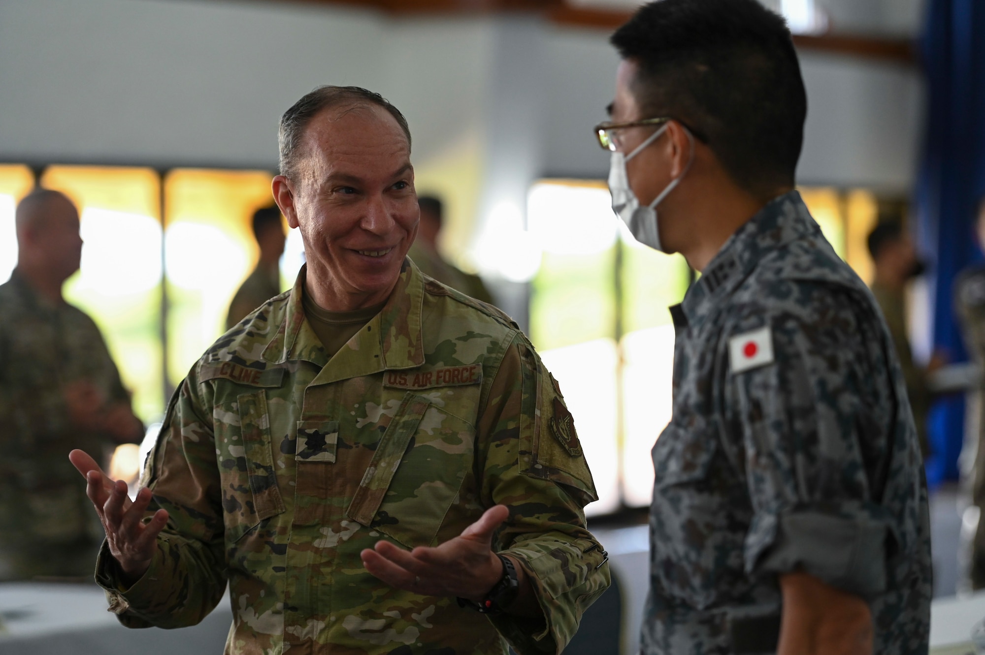 U.S. Air Force Lt. Col. Scott Cline, Chief of Civil Engineer Division, Fifth Air Force Headquarters, speaks with a member of the Japan Air Self-Defense Force during the Pacific Unity Multi-Lateral Civil Engineer Key Leader Engagement, June 22, 2022 at Andersen Air Force Base, Guam. Themes during this KLE included topics of shared interest across the allies and partners such as joint capabilities, leveraging expertise in the Total Force, and increased frequency of subject matter expert exchanges and multi-lateral training.   (U.S. Air Force Photo by Airman 1st Class Emily Saxton)