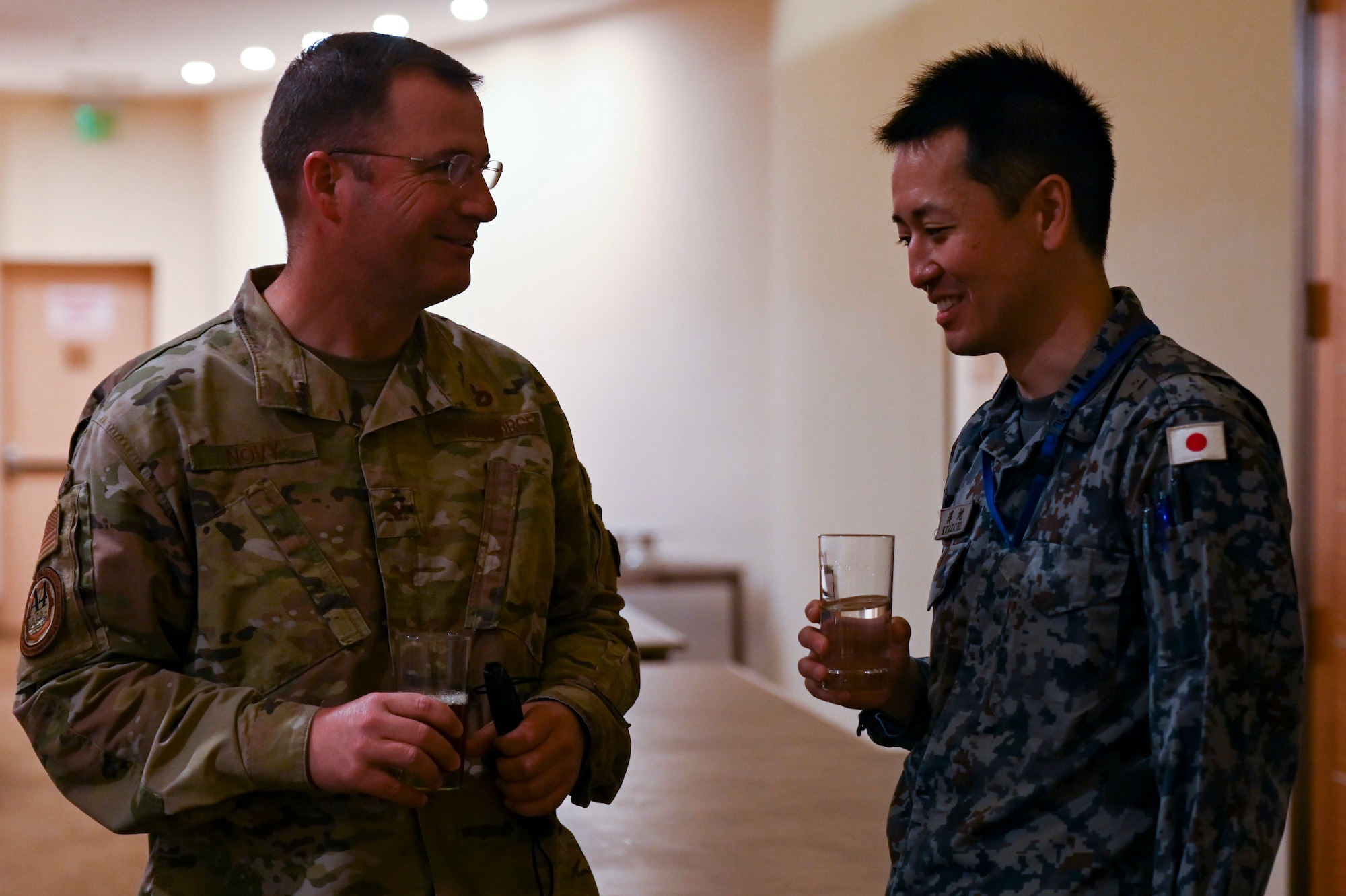 U.S. Air Force Col. David Novy, Chief of the Civil Engineer Division, Pacific Air Forces, talks with a member of the Japan Air Self-Defense Force during the Pacific Unity Multi-Lateral Key Leader Engagement, June 24, 2022 at Andersen Air Force Base, Guam. Themes during this KLE included topics of shared interest across the allies and partners such as joint capabilities, leveraging expertise in the Total Force, and increased frequency of subject matter expert exchanges and multi-lateral training. (U.S. Air Force Photo by Airman 1st Class Emily Saxton)