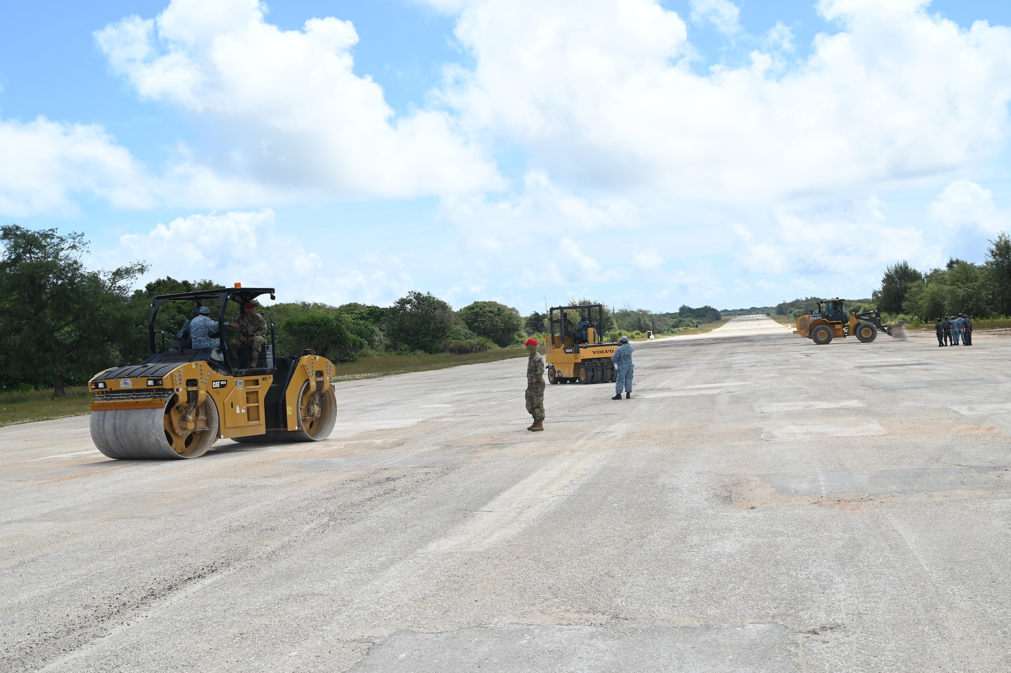U.S. Air Force and Republic of Singapore Airmen operate heavy machinery during Silver Flag at Northwest Field, Guam, June 30, 2022.