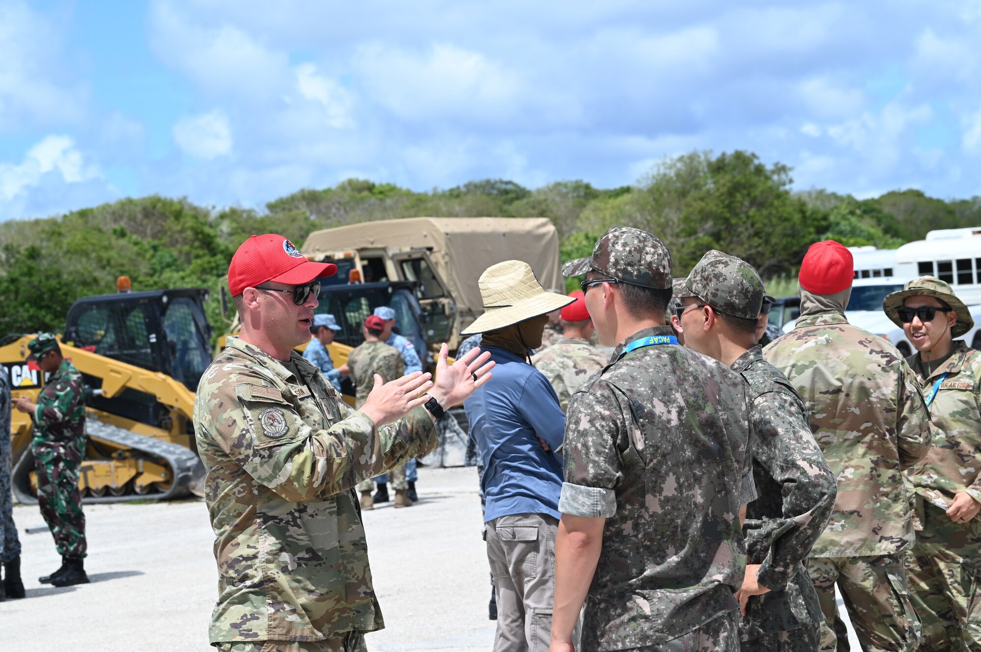 U.S. Air Force Master Sgt. Eric Gibson, emergency management contingency training NCO in charge assigned to 554th RED HORSE Squadron, speaks to Japan Air Self-Defense Force Airmen during Silver Flag on Northwest Field, Guam, June 30, 2022.